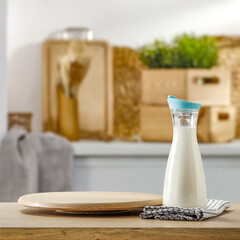 Fresh cold milk in bottle and kitchen interior. Free space for your decoration 