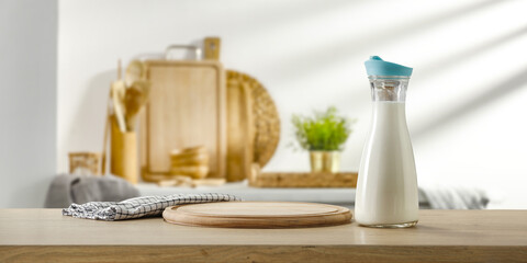 Fresh cold milk in bottle and kitchen interior. Free space for your decoration 