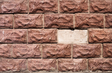 A wall without one brick. Red textured brick. Abstract background.