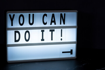 A lightbox with text You can do it! with the letter Y dropped. Motivational concept