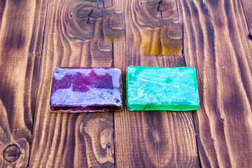 Purple and green toilet soap on dark background