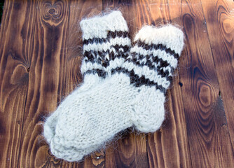 Knitted socks with natural wool on a dark background
