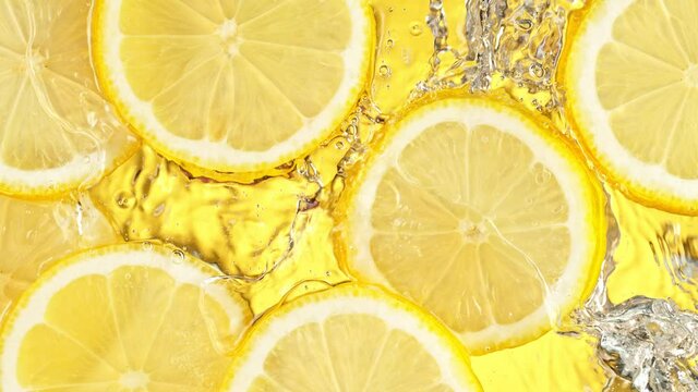 Super Slow Motion Shot of Splashing Fresh Lemon Slices into Water at 1000 fps.