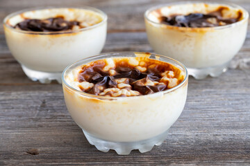 Rice pudding on wood floor. Rice pudding is a dessert made with rice and milk.