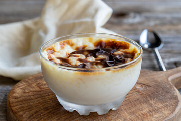 Rice pudding on wood floor. Rice pudding is a dessert made with rice and milk.