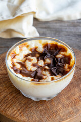 Rice pudding on wood floor. Rice pudding is a dessert made with rice and milk.