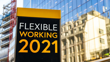 Flexible Working 2021 on a city-center sign in front of a modern office building