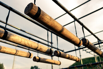 Obstacle course race ocr, horizontal logs in a row, sunset