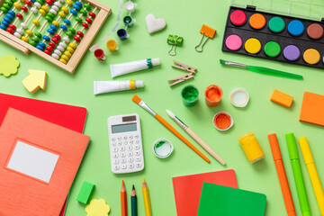 School supplies flat lay. Stationery on green pastel color background, Education, Back to School, kids creativity concept