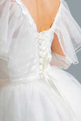Fototapeta na wymiar White dress of the bride. Light fabric texture. Traditional wedding wear.