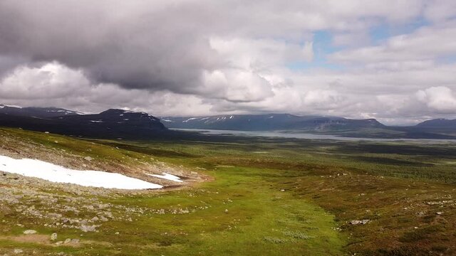 Drone footage of Kungsleden trail between Sitojaure and Aktse, July. Snow is still melting in Lapland, Sweden
