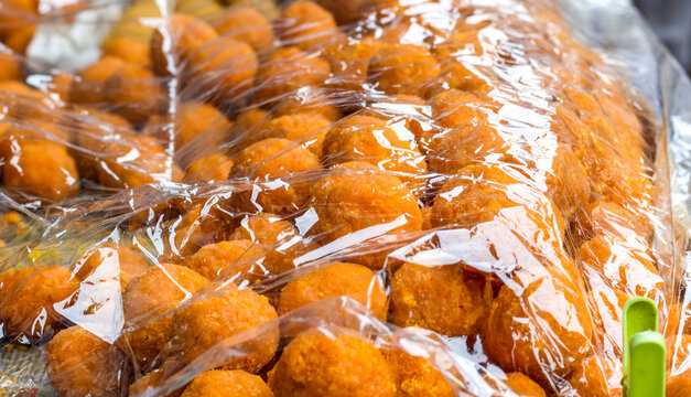 Indian dessert dry sweet rasgulla selling in the street close up