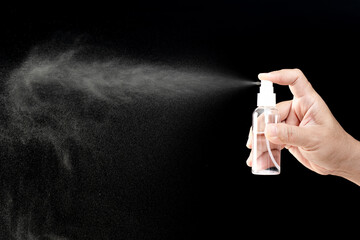 Dark photo concept of hand a man Press the alcohol spray bottle for protection cleaning and...