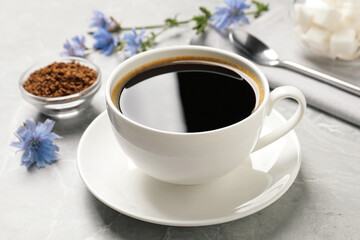 Cup of delicious chicory drink on light grey marble table, closeup