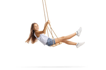 Beautiful girl with long hair swinging on a wooden swing - obrazy, fototapety, plakaty
