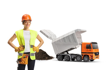 Female construction worker and a truck unloading debris