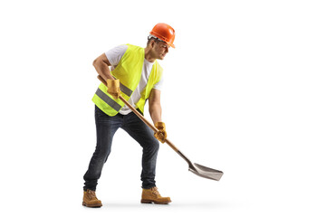 Construction worker with a vest and hardhat using a shovel