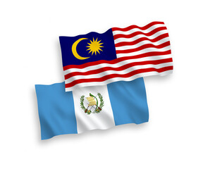 National vector fabric wave flags of Republic of Guatemala and Malaysia isolated on white background. 1 to 2 proportion.