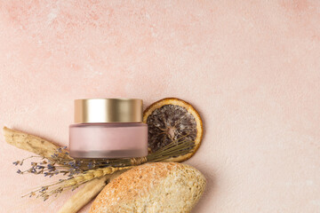 Obraz na płótnie Canvas Pink jar of cream with natural ingredients