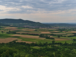 Fototapeta na wymiar Beautiful aerial view over the foothills of northern Swabian Alb from Limburg hill near Weilheim an der Teck, Germany with village Bissingen.