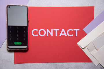 Obraz premium Contact text on red and purple background flat lay concept.