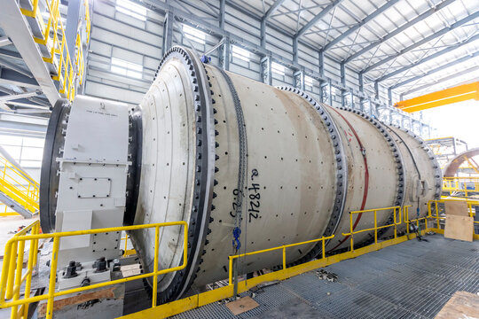 View of the large sag and ball mill in the mine factory. A ball mill is a type of grinder used to grind and blend materials for use in mineral dressing processes.