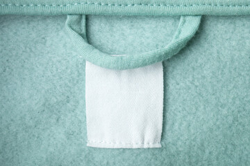 Cotton laundry care clothing label on fabric texture with place for text on fabric texture. Clothes...