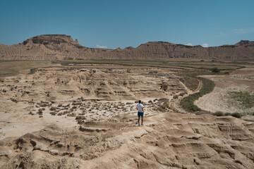 A man hiking in the desert of Bardenas Reales.