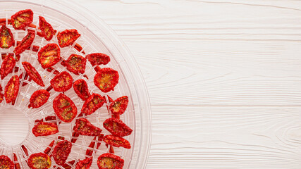 Top view of tray with sun-dried tomatoes for use in dehydrator with copy space