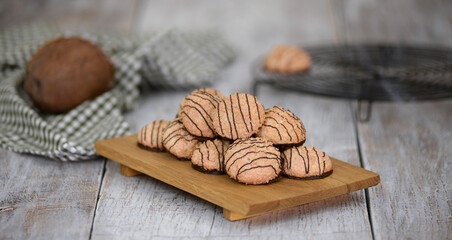 Homemade coconut cookies poured with chocolate. Coconut biscuits with chocolate