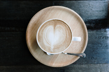 Foamed milk latte heart, Cup of hot coffee on the table in a cafe