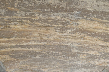 Closeup of textured rock rough stone wall. Artistic background.