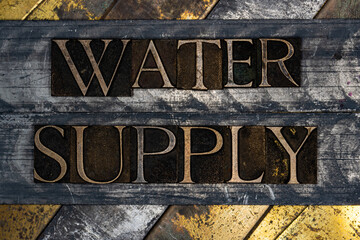 Water Supply text message on vintage textured grunge copper and gold background