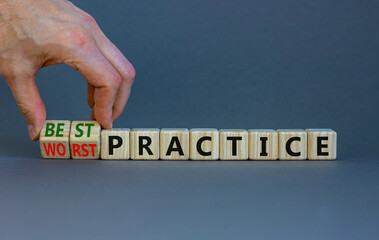 Best or worst practice symbol. Businessman turns wooden cubes and changes words 'worst practice' to...