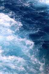 Obraz na płótnie Canvas Sea foam and deep blue sea. Selective focus.