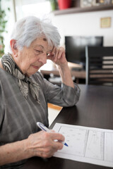 Focused senior gray-haired Caucasian woman doing Self-Administered Gerocognitive Examination test...