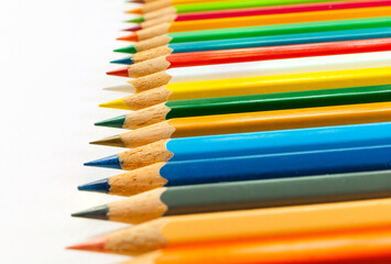 Obraz premium Right side view of various colored pencils. placed isolated on white background and colored pencils in close-up.Concept art Text copy space and office