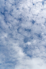 Obraz premium The background image of a beautiful blue sky with some white clouds in the daytime.