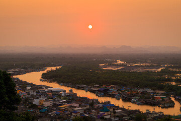Fototapeta na wymiar Pak Nam Chumphon town, fisherman village, and river from Khao Matsee scenic viewpoint during sunset, Thailand