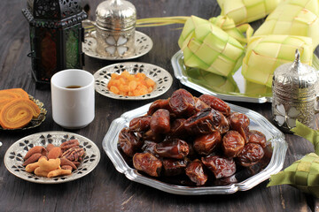 Dried Dates Fruit with Ketupat, Turkish Tea, and Honey for Ied Mubarak adn ramadan Kareem Snack