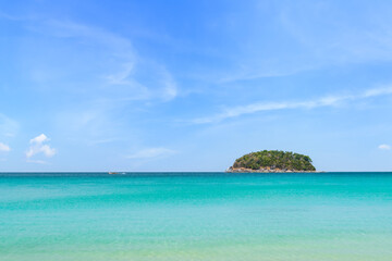 Fototapeta na wymiar Crystal clear water and island at Kata Beach, famous tourist destination and resort area, Phuket, Thailand