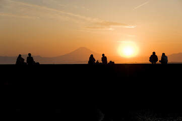 Couples watch Mount Fuji at sunset from Enoshima Island in Kanagawa Prefecture, Japan
