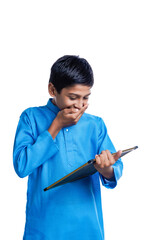 Indian school boy holding chalkboard in hand on white background.