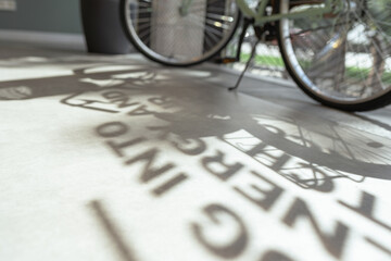 Abstract blurry shade on floor. Interior abstraction with defocused bicycle wheels on background. Concept of college students, knowledge, read text, running letters