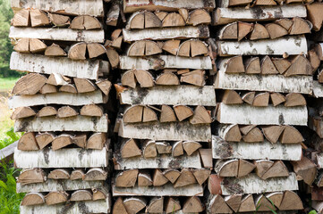 Birch firewood stacked in rows front view