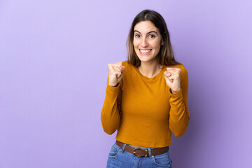 Young caucasian woman over isolated background celebrating a victory in winner position