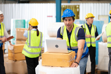 engineer or factory worker using laptop computer, talking with someone and surprise to something