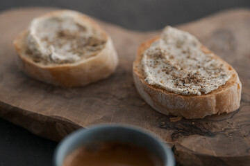 Espresso in blue cup with sandwiches with cream cheese on background