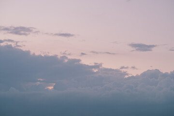Evening clouds in the sky in summer evening with warm light