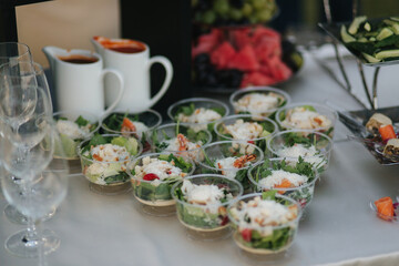 Tasty salad in disposable dishes is served table at summer terrace in restaurant. Food concept
